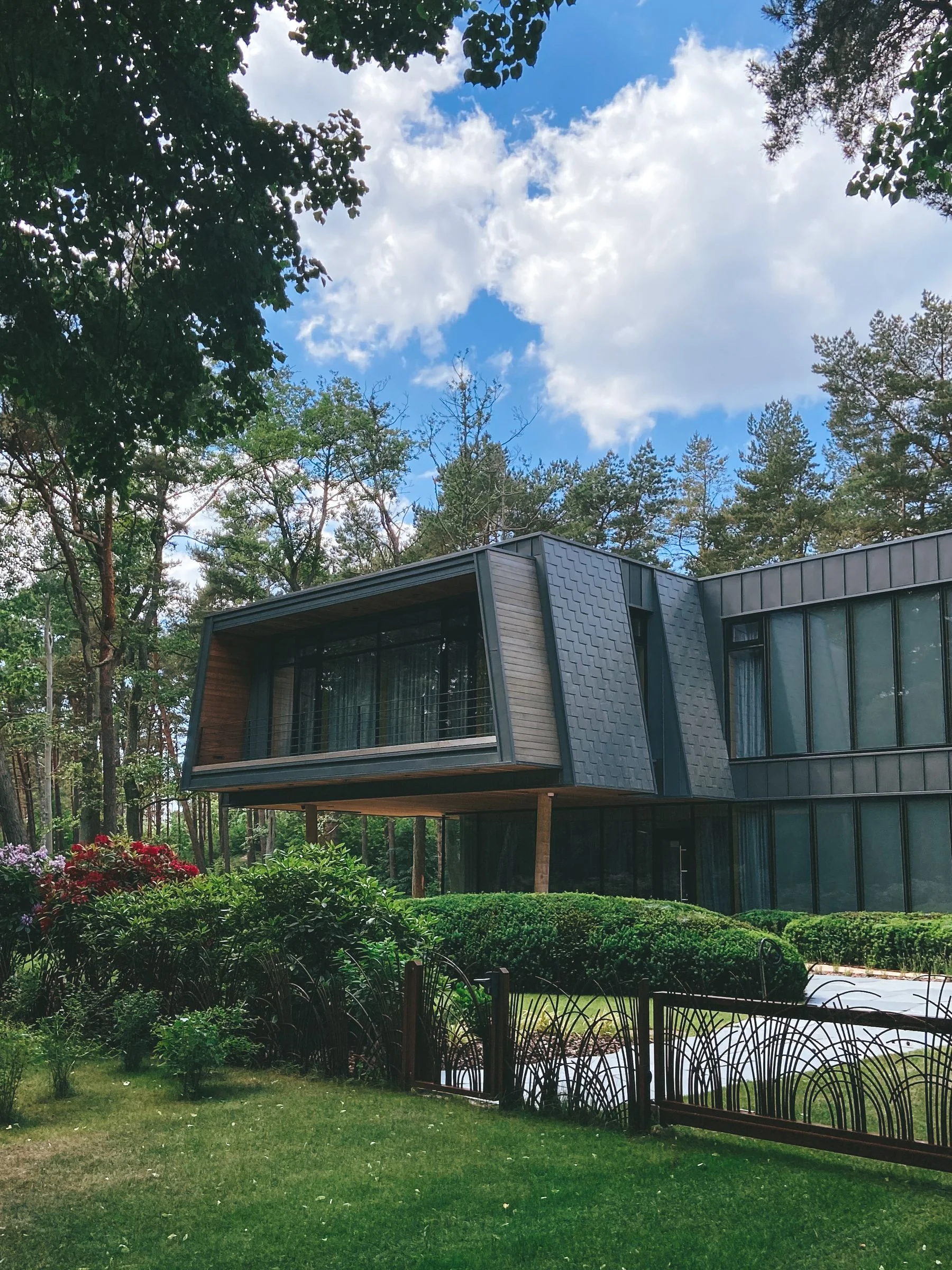 Contemporary home exterior surrounded by a green landscaped garden